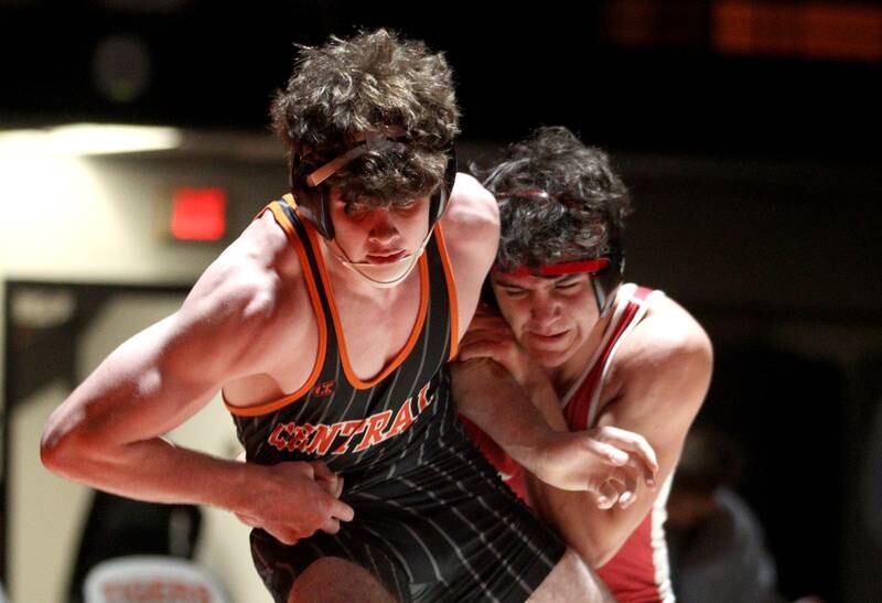 Crystal Lake Central’s Tyler Porter, left, battles Huntley’s Alex Napientek in a 165-pound bout in varsity wrestling at Crystal Lake Friday.  Napientek won the match.