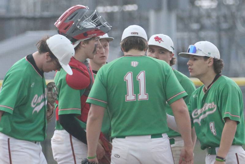 Members of the L-P baseball team talk amongst each other on the mound after Kaneland scored four runs in one inning on Thursday, April 11, 2024 at Huby Sarver Field in La Salle.