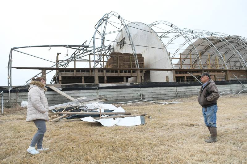 Sara Morris, administrator, and Dave Diveley, property manager, stand by the damaged building at Pegasus Special Riders on Sunday. The main building that houses the arena for the therapeutic horseback riding center, was damaged by Saturday night's strong winds. Officials are awaiting an insurance assessment and at this point are unsure how and when repairs can be made. No horses were injured.