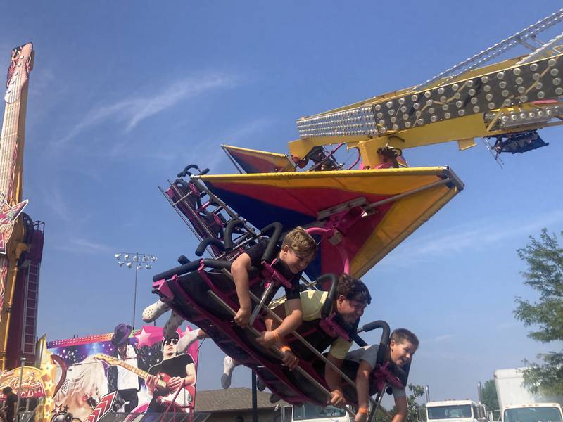 Attendees of the Shorewood Crossroads Festival carnival ride the "Cliff Hanger" spinning ride on Saturday, August 2, 2025.