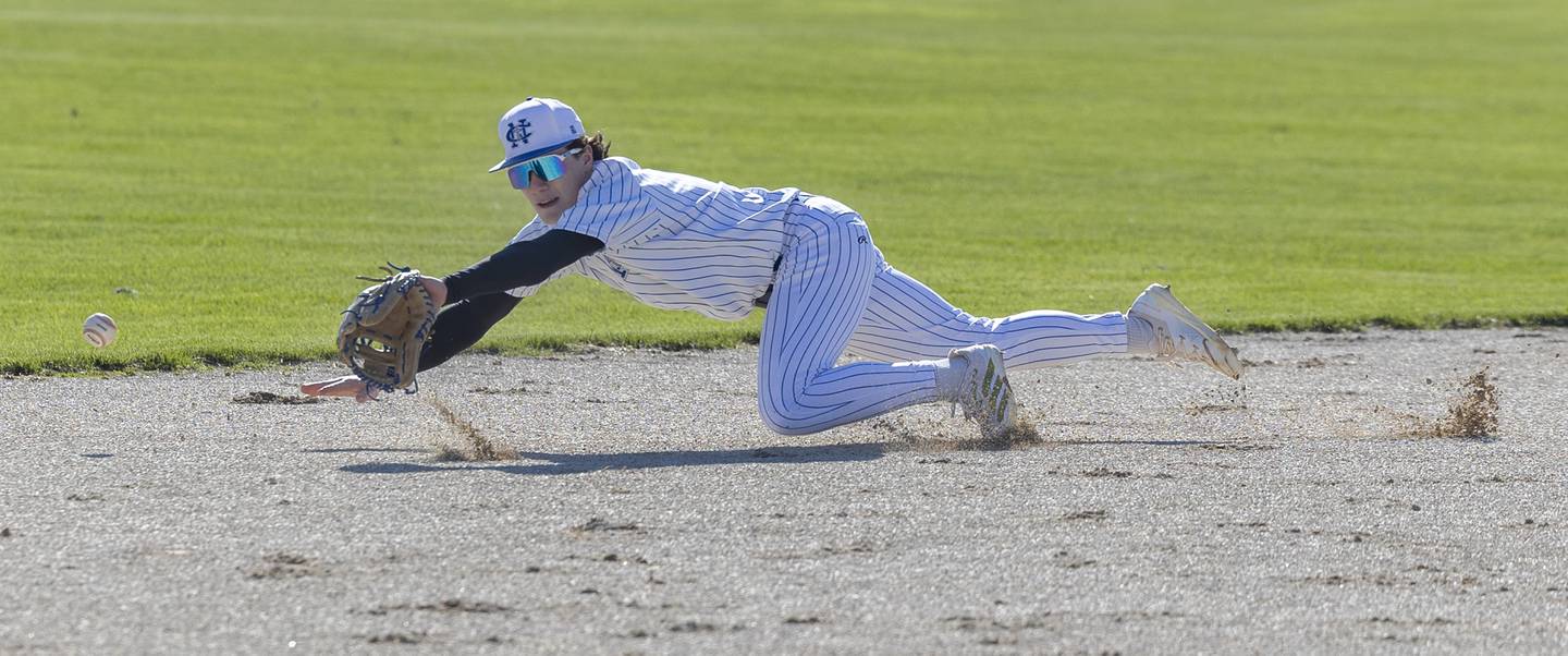 Newman’s Garret Matznick dives but comes up short on a grounder against Princeton Monday, April 6, 2026.