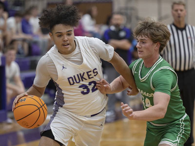 Dixon’s Darius Harrington drives to the basket against Geneseo’s Aiden DeCap Monday, Nov. 25, 2024.