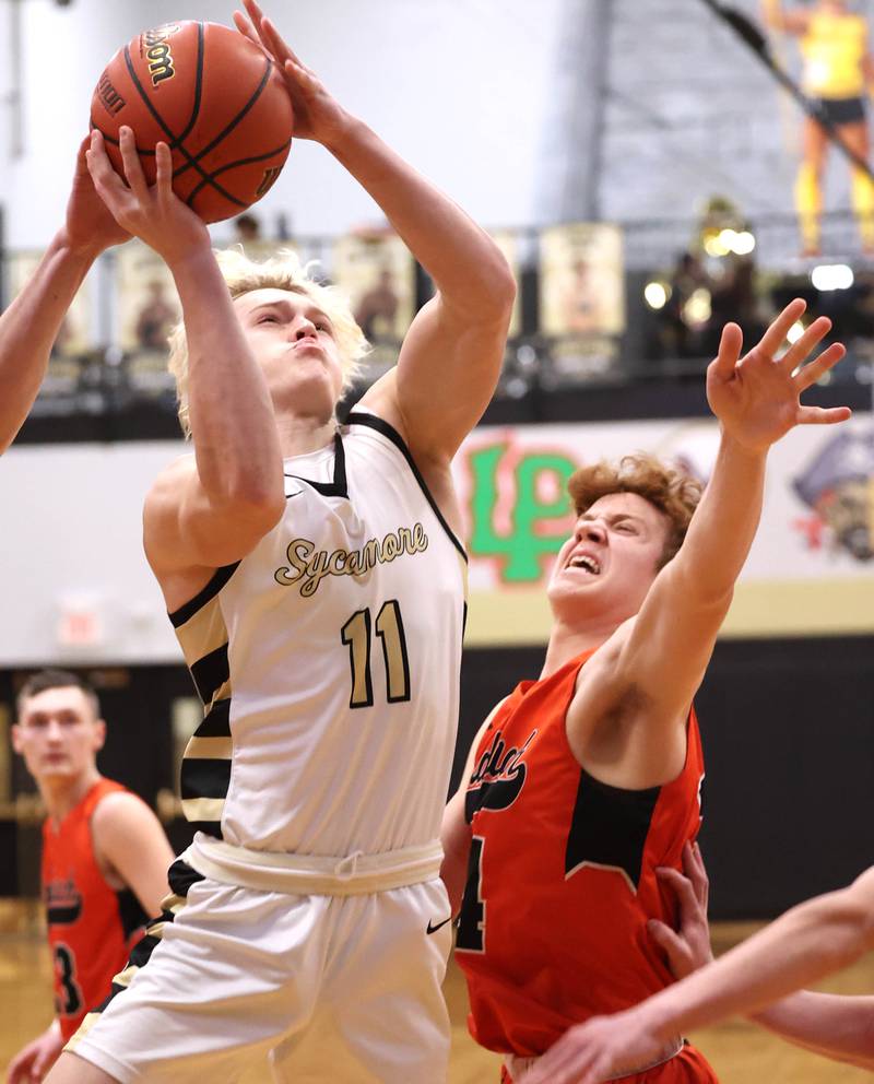 Sycamore's Burke Gautcher shoots over Sandwich's Dom Rome during their game Tuesday, Jan. 17, 2023, at Sycamore High School.