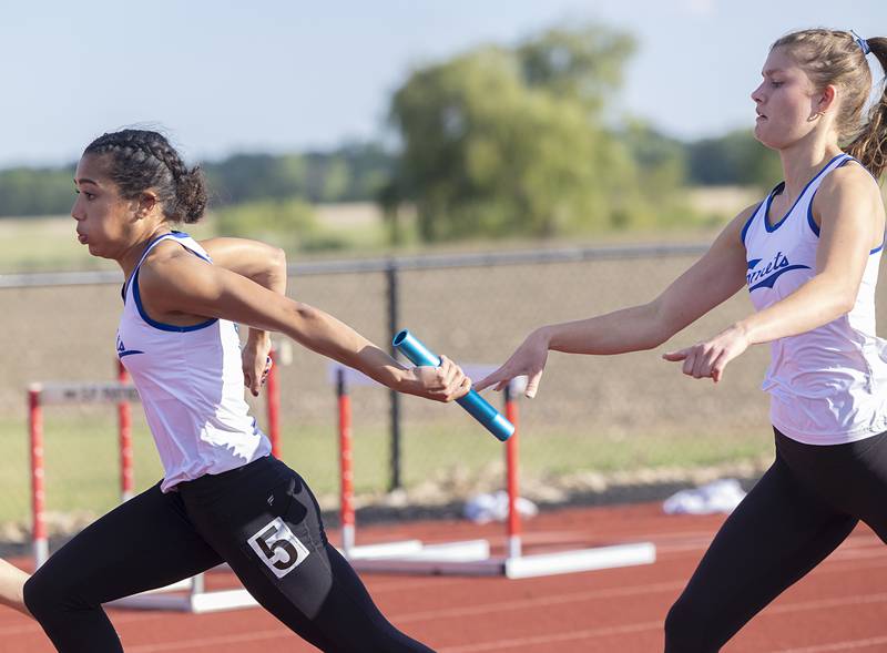Newman’s Paizlee Williams takes the baton from Lauren McClain in the 4x100 Wednesday, May 13, 2026, during the Class 1A Erie Sectional meet.
