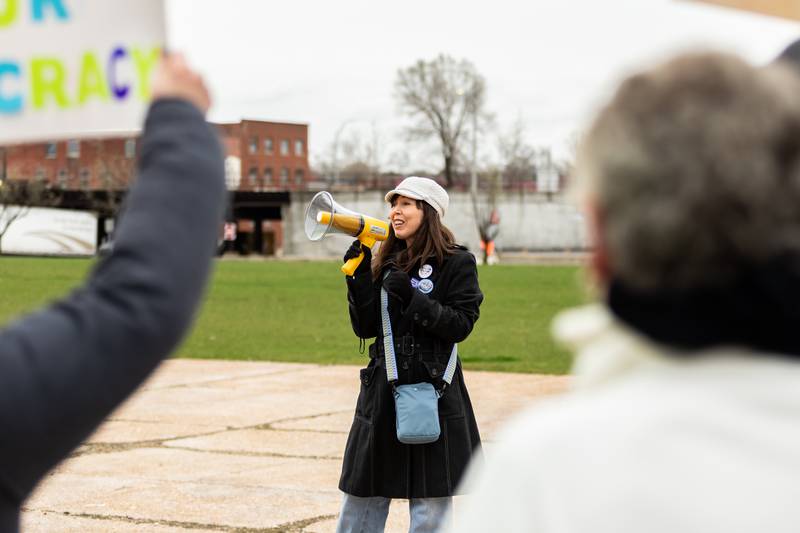 Katie Kollross, with the Illinois Federation of Teachers, welcomes everyone to the Hands Off protest in Downtown Joliet on April 5, 2025.
