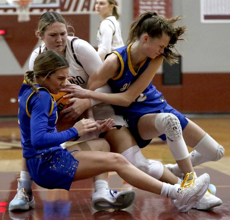 Marengo's Maggie Hanson (center) battles with Johnsburg's Ava Jablonski (right) and Johnsburg's Skye Toussaint (right) for a rebound Kishwaukee River Conference basketball game on Saturday, Feb. 1, 2025, at Marengo High School.