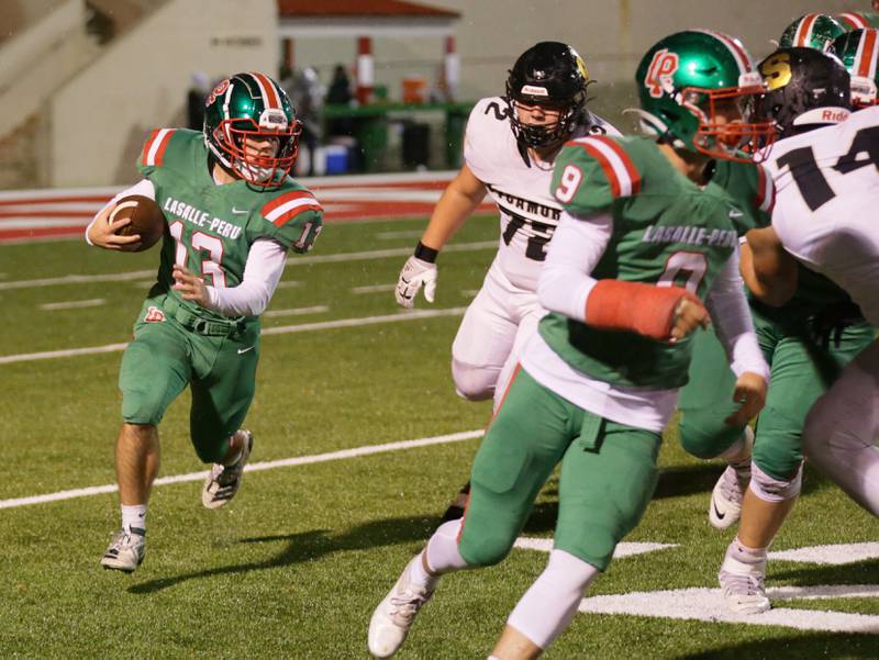 L-P's Brady Romagnoli (13) runs the ball against Sycamore on Friday, Oct. 14, 2022 at Howard Fellows Stadium in Peru.