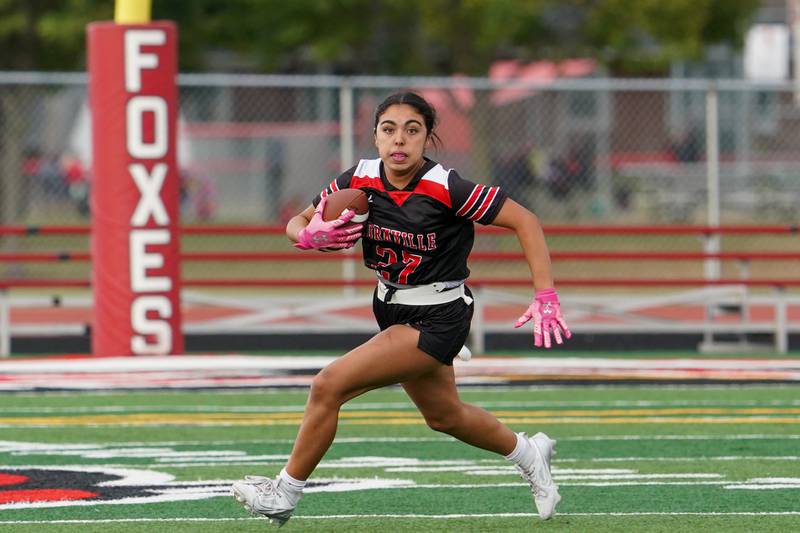 Yorkville's Bella Esquivel (27) carries the ball against Joliet Central during a flag football game at Yorkville High School on Monday, Sep 23, 2024.