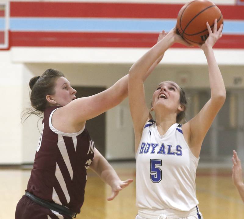 Marengo’s Addie Johnson fouls Rosary’s Tes Ketterman as she shoots the ball during a IHSA Class 2A Regional semifinal basketball game Monday evening, Feb. 14, 2022, between Marengo and Rosary at Marian Central High School.
