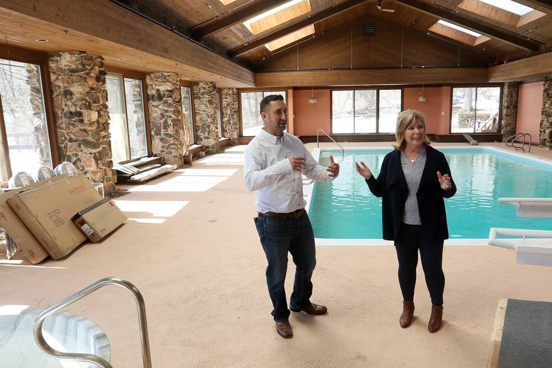 Shepherd Premiere Senior Living co-owners Brandon Schwab, left, and Theresa Maskrey show the bottom floor of the residence which is not a part of the senior home on Monday, March 1, 2021 in Bull Valley.  The senior residence located at 1101 Cherry Valley Road is the former home of David Soskin prior to a drug bust seizure of 350 lbs of marijuana on the property.