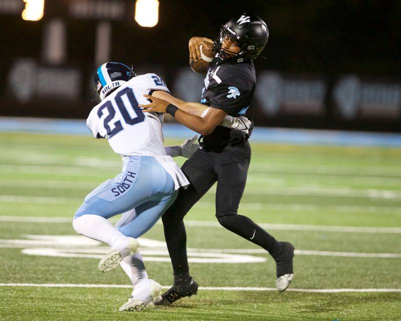 Willowbrook's Kenneth Rhodes tries to avoid the tackle by Downers Grove South's Coen Godenschwager on Friday, Sept. 20, 2024 in Villa Park.