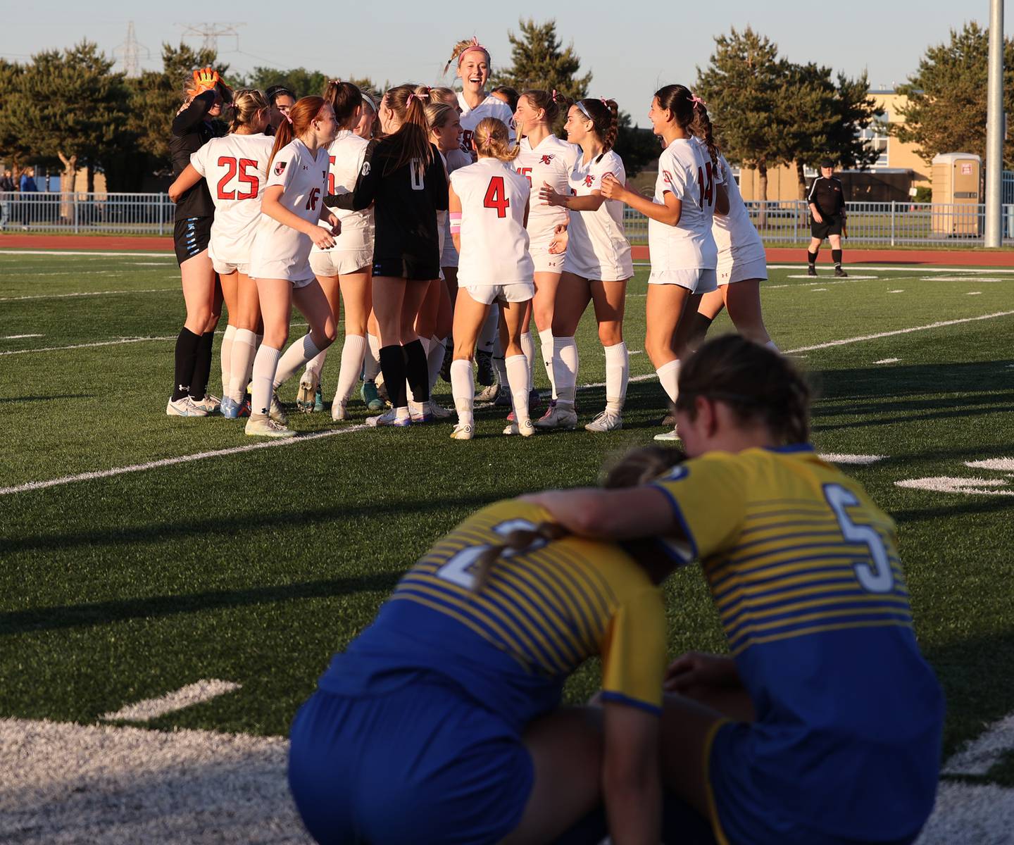 Hinsdale Central celebrate their win as Lyons Township console each other after the IHSA Class 3A girls soccer sectional final match between Lyons Township and Hinsdale Central at Reavis High School in Burbank on Friday, May 26, 2023.