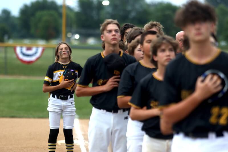 Players observe the playing of the national anthem during MCYSA 2023 Summer International Championships Opening Ceremonies Friday, June 14, 2023, at the Mickey Sund Complex in Lippold Park in Crystal Lake.