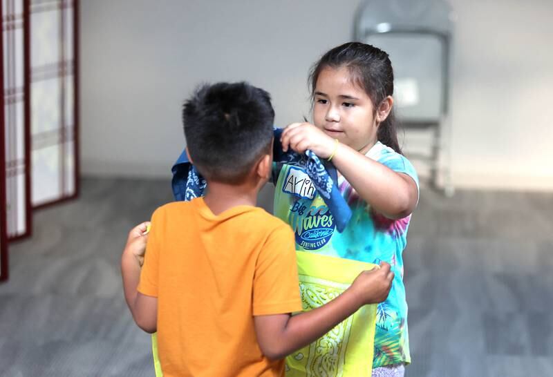 Aylin Salazar, (right) 7, from DeKalb, helps Ayden Lythcke, 7, from Sycamore, get his blindfold on Monday, July 11, 2022, as they get ready for an activity about the sounds of animals on farms during a session of Summer Reading Vacation put on by Neighbors' House in DeKalb in conjunction with the DeKalb County Farm Bureau. Christ Community Church is hosting the camp this week in their outreach center on North 6th Street in DeKalb.