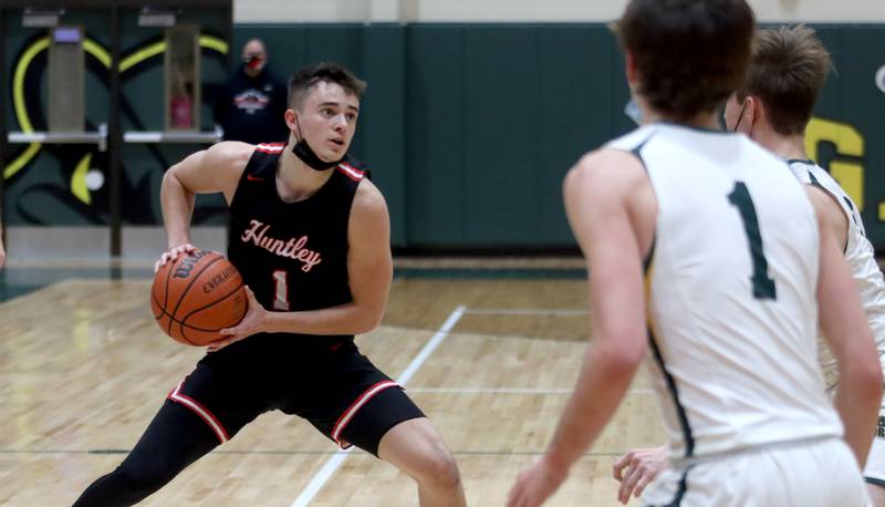 Huntley’s Ben Ahmer looks for an option in boys varsity basketball at Crystal Lake South Friday night.