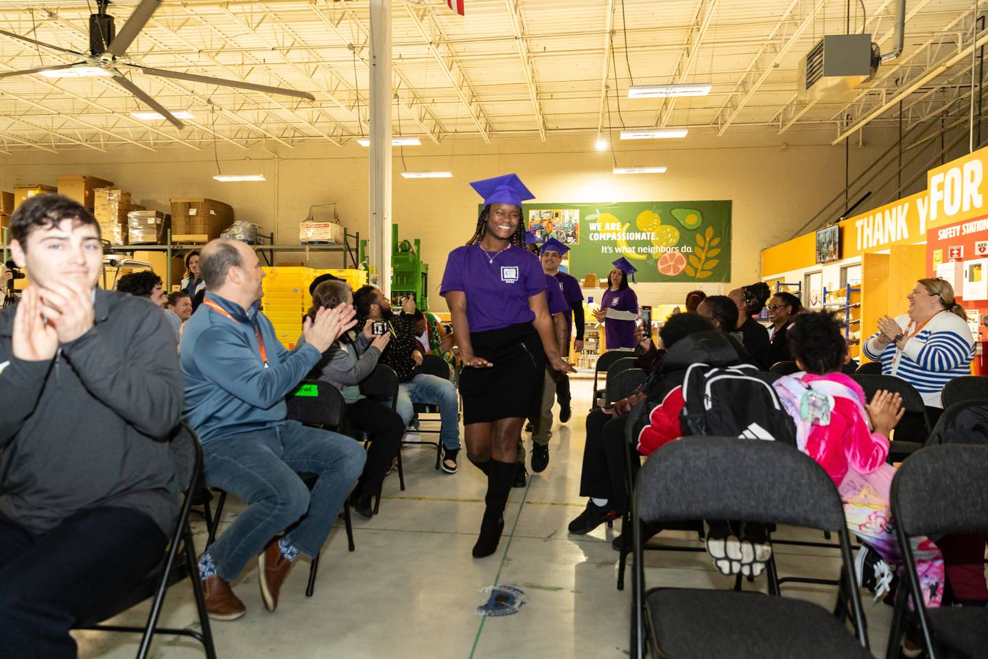 Connie Jackson leads the 'Pomp and Circumstance' procession during the S.E.E.D. graduation at the Northern Illinois Food Bank South Suburban Center in Joliet on March 14, 2024.