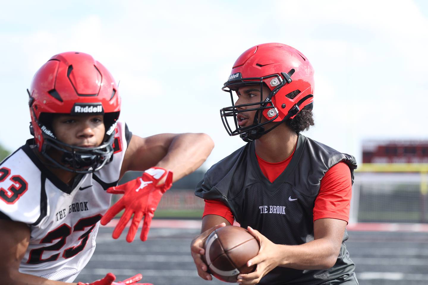 Bolingbrook’s Jonas Williams fakes a handoff to Kale Cook during the first day of practice on Monday, Aug. 7, 2023 in Bolingbrook.