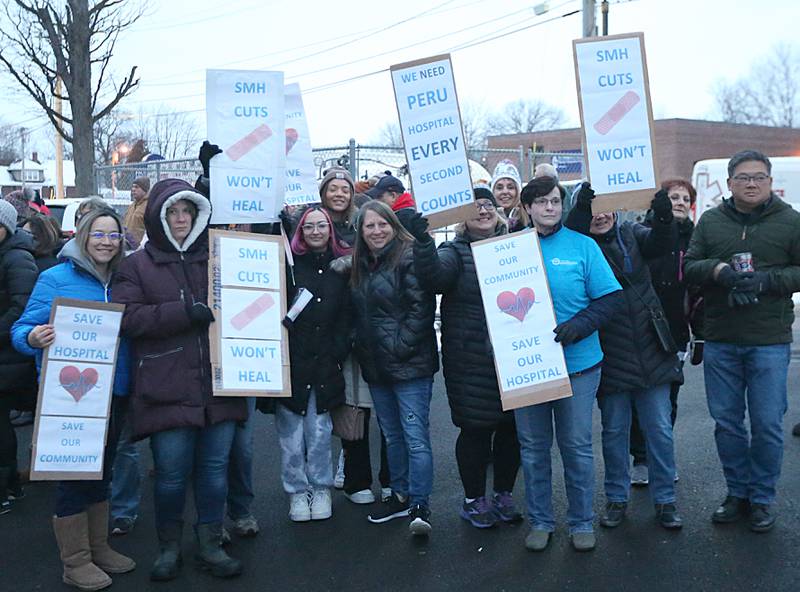 St. Margaret's employees hold signs as they gather outside outside St. Margarets Hospital (formally Illinois Valley Community Hospital) on Saturday, Jan. 28, 2023 in Peru. Employees and former employees gathered at the hospital after it closed at 7a.m. on Saturday morning. Hospital officials announced late last Friday their plans to suspend operations at St. Margaret's Health in Peru.