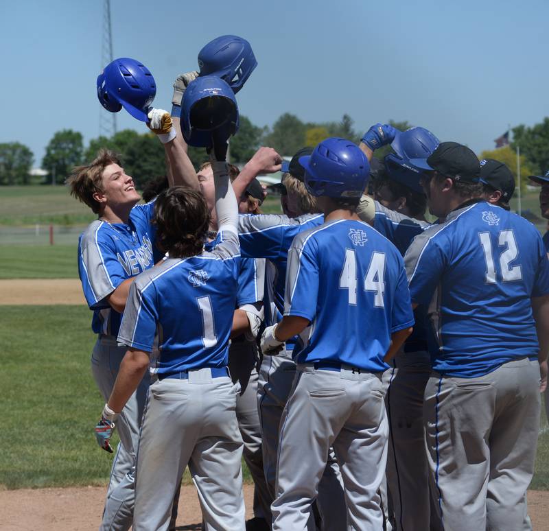 Newman's Brendan Tunink (far left) is greeted at home plate after hitting one of three home runs against Dakota at the 1A Pearl City Sectional championship on Saturday, May 27.