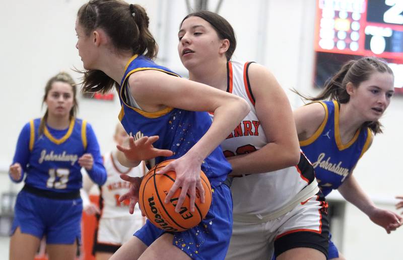 McHenry’s Brooklyn Anderson, back, tussles with Johnsburg’s Skye Toussaint for the ball in varsity girls basketball on Saturday, Jan. 4, 2025, at McHenry High School in McHenry.