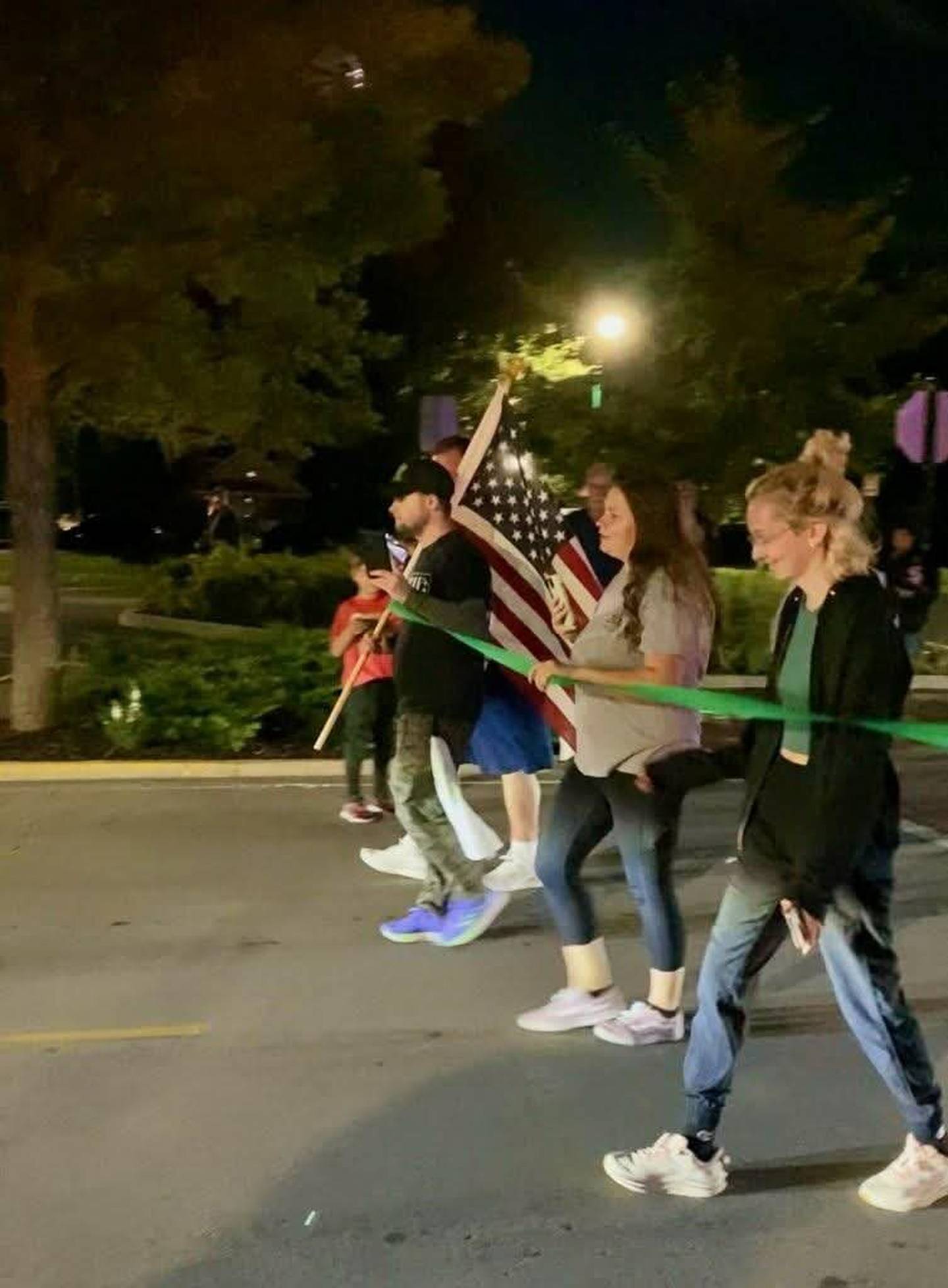 Jake Smith and supporters cross a finish line during Smith's annual walk for mental health and suicide prevention awareness in Manteno on Saturday, Sept. 6, 2025.