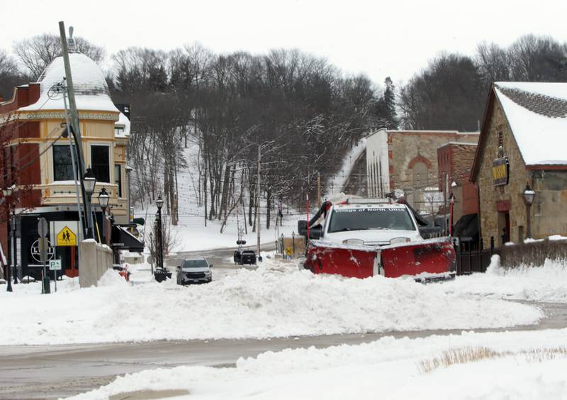 A village of North Utica snowplow pushes snow down Mill Street on Thursday, Feb. 3, 2022.