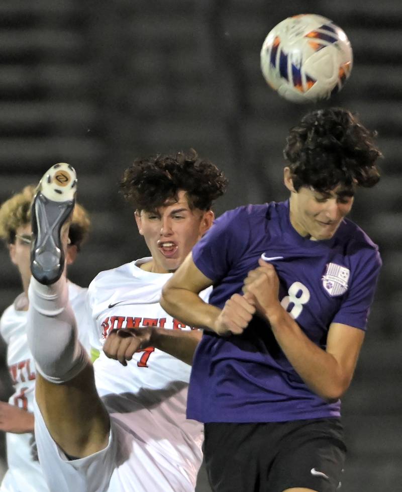 Huntley’s Mason Leslie just misses Hampshire’s Javier Gonzalez Martinez with a kick in an IHSA Class 3A boys soccer sectional semifinal game in Streamwood on Oct. 30, 2024.