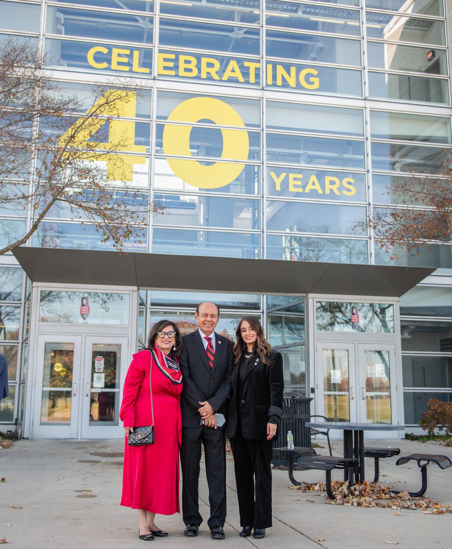 Former NIU College of Engineering Dean Promod Vohr (middle) a is flanked by his wife, Anju, (left) and his daughter, Divya Behl (right) outside NIU's Engineering Building on Nov. 14, 2025. The father and daughter were inducted together int he hall of fame this year.