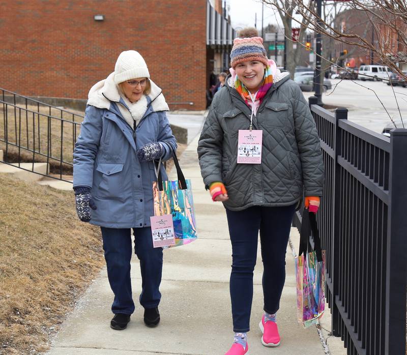 Karla and Kati Richards stroll down Main Street during the 8th Annual Chocolate Walk for Charity in Oswego on Saturday, Feb. 8, 2025.