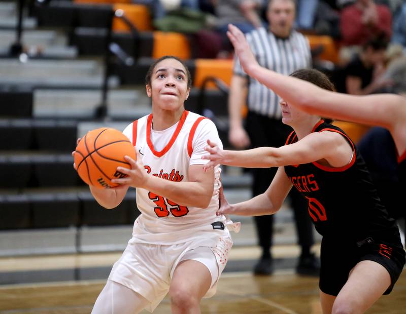 St. Charles East's Corinne Reed looks for an opening during a game against Wheaton Warrenville South on Tuesday, Feb. 11, 2025 in St. Charles.