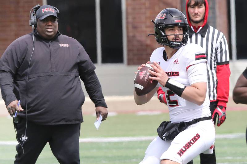 Northern Illinois quarterback Ethan Hampton throws a pass as head coach Thomas Hammock looks on during the Spring Showcase Saturday, April 22, 2023, at Huskie Stadium at NIU in DeKalb.