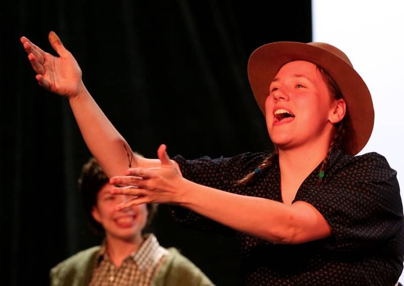 Chloe Clayton (foreground) acts out a scene during a rehearsal of "The Trail to Oregon!" while Allesyn Wilke looks on during rehearsals Wednesday, Sept. 5, 2024, at Stage 212 in La Salle.