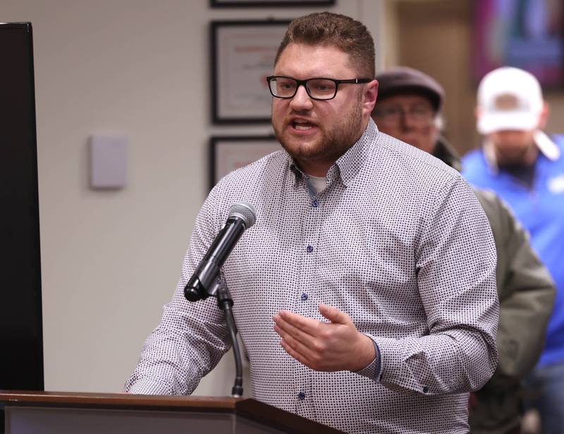 Christopher Boyes, DeKalb School Board President, talks Monday, Dec. 1, 2025, during public comment, about some of the positive aspects that the proposed 560-acre data center would have on the community during the Planning and Zoning Commission hearing at the DeKalb Public Library.