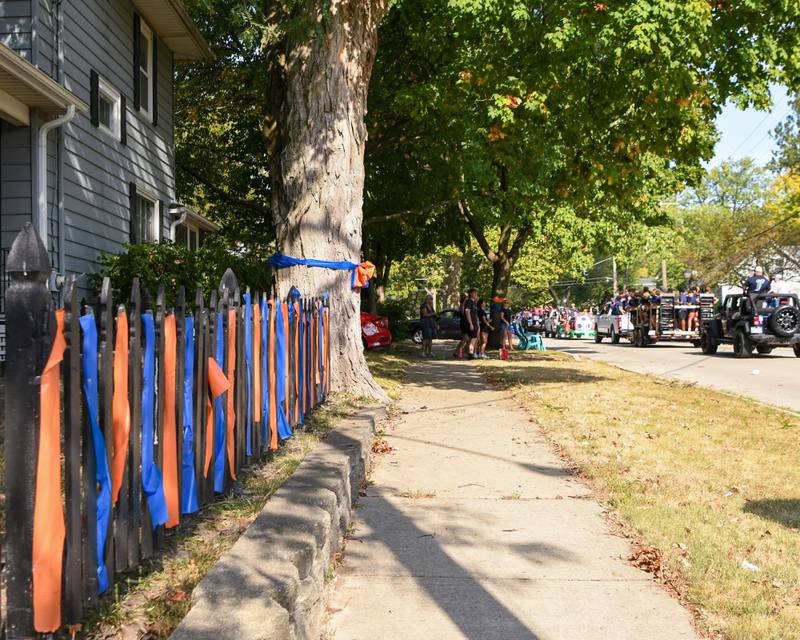 Orange and blue ribbons hang from a fence post during the Oswego High School homecoming parade on Sunday Sept. 15, 2024, that traveled through downtown Oswego.