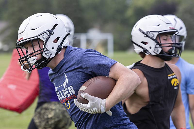 Jake Whelan runs the ball for Dixon Monday, Aug. 12, 2024 during first day of football practice.