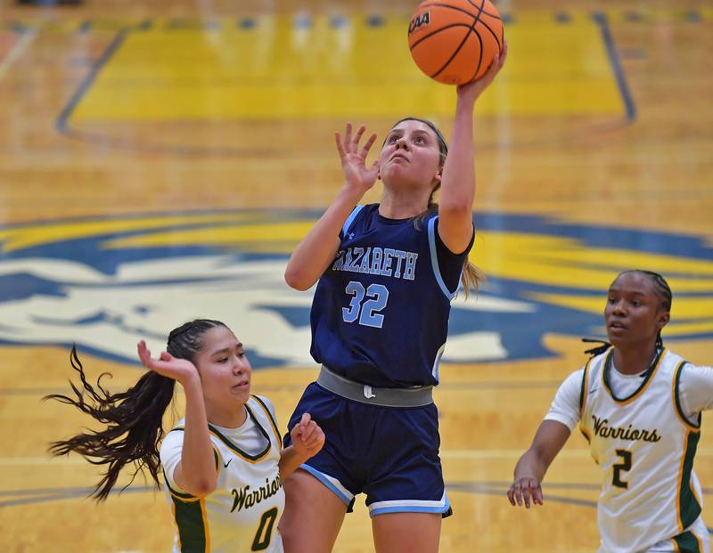 Nazareth’s Stella Sakalas (32) shoots from between Waubonsie Valley’s Maya Pereda (0) and Syncere Williams during the Class 4A Lyons Supersectional game on March 2, 2026 at Lyons Township High School in LaGrange.