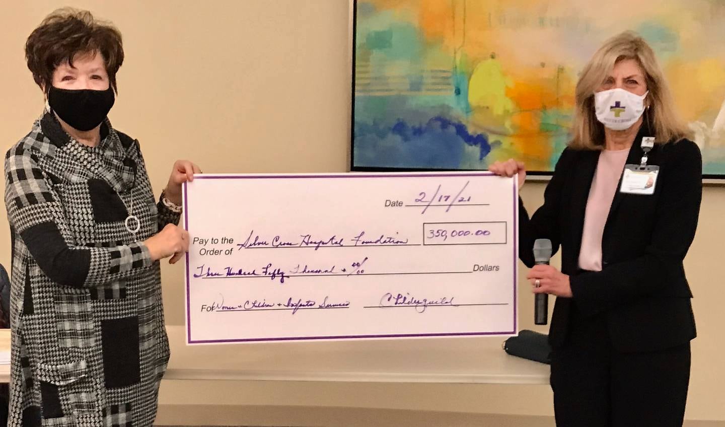 Childerguild President Pam Resutko (left) presented Silver Cross Hospital President & CEO Ruth Colby with a check for $350,000 on Feb. 19 to fund help fund women and children services including Will County’s first neonatal intensive care unit.