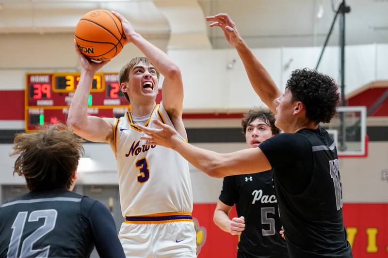 Downers Grove North's Nolan Hurter (3) shoots the ball in the post against Oswego East's Damien Lewandowski (10) during a Batavia Night of Hoops Basketball game at Batavia High School on Saturday, Jan. 25, 2025.