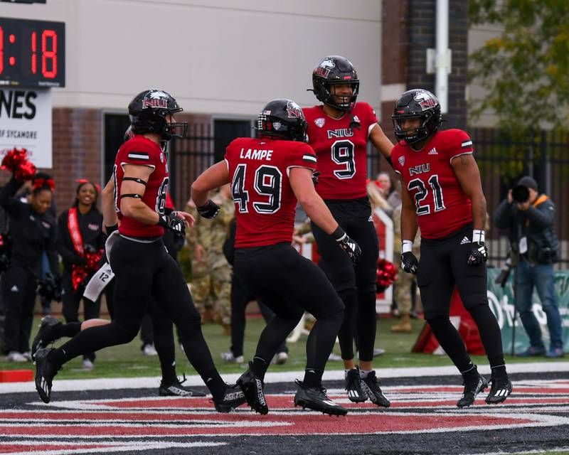 NIU Gavin Williams, right, celebrates with teammates in the endzone after scoring a touchdown in the first quarter during the 116th homecoming game on Saturday Oct. 14, 2023, while taking on Ohio University at Huskie Stadium in DeKalb.