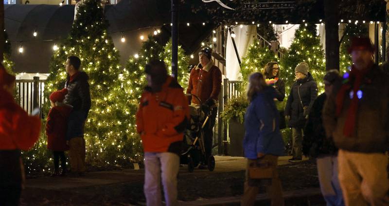 Festive lights line Third Street as the annual Christmas Walk begins Christmas with the arrival of Carolers, Santa Lucia and Santa Claus Friday, Dec. 6, 2024 in Geneva.