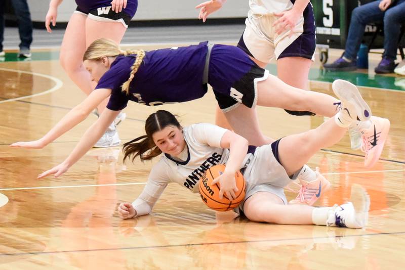 Manteno's Lila Prindeville, bottom, grabs a loose ball below a diving Nina Egizio of Wilmington during the IHSA Class 2A Seneca Regional championship Thursday, Feb. 19, 2026.