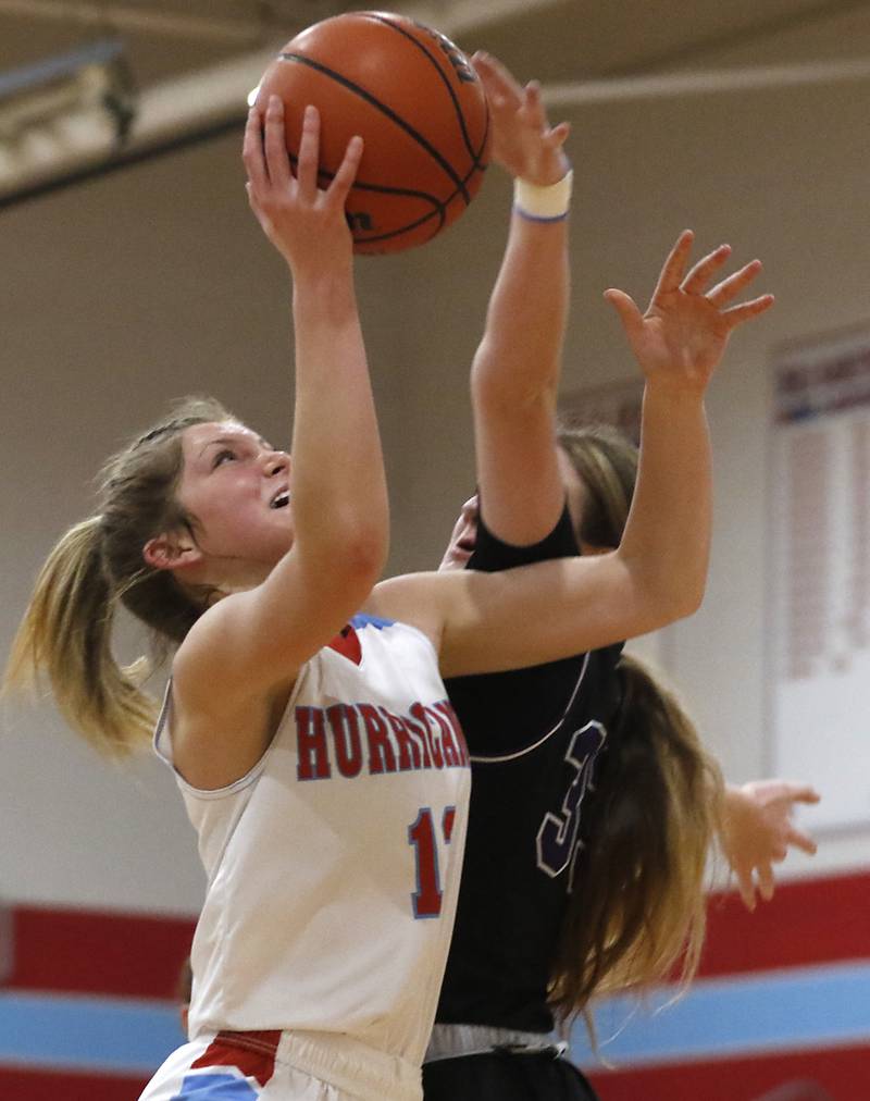 Marian Central's Lucy Iden tries to shoot the ball over Rockford Lutheran's Kaylee Bankes during a non-conference girls basketball game Monday, Dec. 12, 2022, between Marian Central and Rockford Lutheran at Marian Central Catholic High School, in Woodstock.