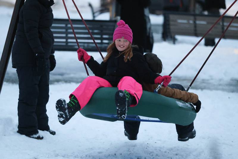 Hailey Hess, 7-years-old, plays on a swing at Plainfield’s holiday kickoff Grinchmas on the Green on Saturday, Dec. 5, 2025 in Plainfield.