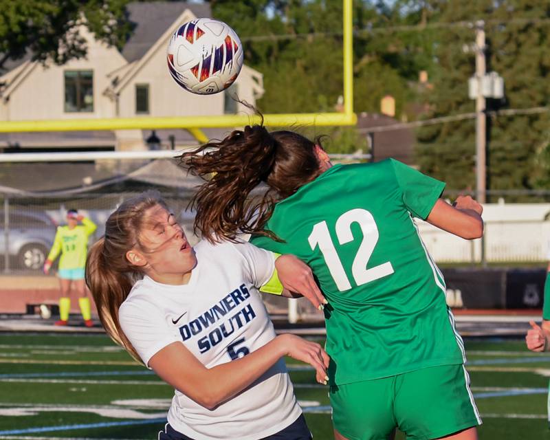 Downers Grove South's Sienna Thurston (5) and York's Ellie Kehoe (12) tries and head the ball during the game on Friday May 23, 2025, during the regional title game held at York High School.