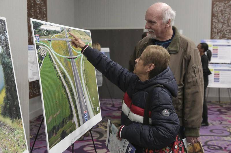 Local residents Rose and Marty Briones interact with mockups of new interchanges on Wednesday at Holiday Inn & Suites in Joliet. The Illinois Department of Transportation held a presentation discussing plans to renovate 16 miles of Interstate 80.