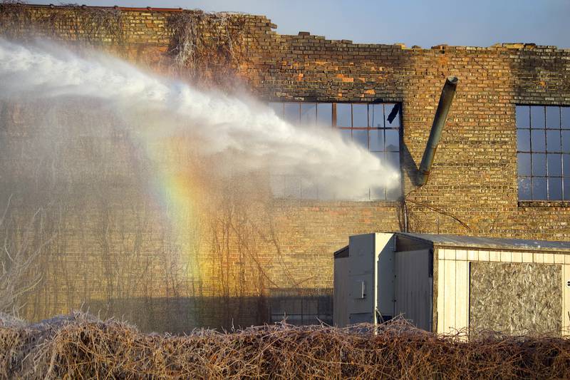 Joliet firefighters at the scene of a fire at an old commercial building on Thursday, Jan. 29, 2026, at the corner of South Eastern Avenue and Washington Street in Joliet.