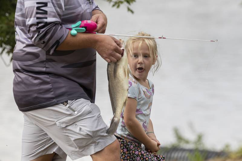 Wrenley Morris, 5, of Dixon checks out the whopper she reeled in Saturday, Sept. 20, 2025, during Dixon PD’s Cops and Bobbers fishing event.