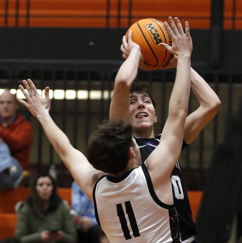 Hampshire's Sean Roth shoots the ball over Crystal Lake Central's Johnny Geisser during a Fox Valley Conference basketball game on Friday, Feb. 7, 2025, at Crystal Lake Central High School.