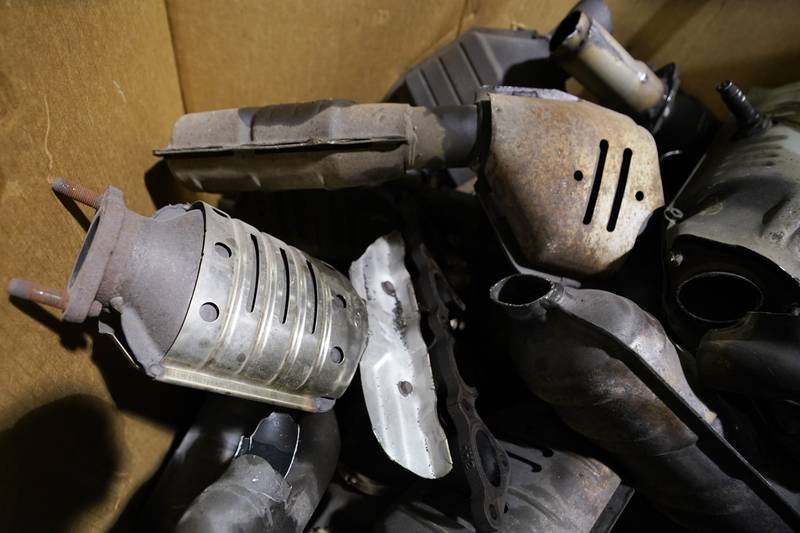 Used catalytic converter that was removed from cars at a salvage yard are piled up in a carton Friday Dec. 17, 2021, in Richmond, Virginia. Thefts of the emission control devices have jumped over the last two years as prices for the precious metals they contain have skyrocketed.