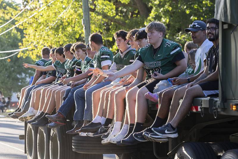 The Rock Falls football team throws candy from a float Thursday, Sept. 25, 2025, during the high school homecoming parade.